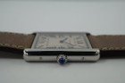 A very nice preowned Cartier Tank Solo reference 3169 in stainless steel, crafted circa 2015. Iterations currently offered in Cartier’s line of offerings, features the standard silvered grained dial with black Roman numerals and chemin de fer, blued steel sword shape hands, and blue spinel cabochon. Can be worn with its steel bracelet for everyday wear, or alternate for the taupe leather strap for a more casual feel. Suitable for men or women.

Minimal scratches.
Original dial, hands and crown. 
Case measures 27.5 x 34.5mm, 5.5mm thick.
Cartier quartz movement.
Sapphire crystal.
Serial# 9110xxxX
Cartier steel bracelet, measures 6 1/4 inches.
Premium non-Cartier taupe leather strap.
20 mm lug width. 
Modeled on a 6 inch wrist.