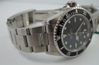 A fine preowned Rolex Submariner non-date reference 14060M in stainless steel originally sold in Hong Kong with papers dated Jan. 2003 and tags, crafted circa 2003. Classic and enduring 40 mm case for casual wear with black bezel, black dial and large lume white round and baton hour markers, and white lume sword-shaped hands. 13 mm silhouette with flip lock steel clasp for secured and comfort fit.

Light wear, small nick located bottom right lug.
Original dial, hands, and crown.
Case measures 40 x 47 mm, 13 mm thick.  
Rolex cal. 3130, highly jeweled automatic winding.
Sapphire crystal.
Serial# Y2135xxx
Rolex flip lock steel bracelet fits 7 3/4 inches.
20 mm between lugs.
Modeled on size 7 3/4 inch wrist.