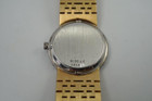 A fine vintage Piaget diamond bracelet watch in 18k yellow gold, crafted during the 1970s. The 25mm round and 5mm silhouette case houses 30 diamonds factory set bezel, approximately 1.20 carats, gold dial and dauphine hands. A beautiful accessory worn elegantly on the wrist for casual or formal wear.

Light scratch on crystal, 7 o’clock position.
Original dial, hands and crown. 
Case measures 25 x 25 mm, 5mm thick.
Piaget cal. 9P, 18 jewels mechanical winding. 
Sapphire crystal.
Serial# 151477 Movement# 6896xx
Piaget bracelet fits 6 1/4 inches or 16 cm approximate, links are removable.
16mm wide bracelet, tapers.
Modeled on a 6 inch wrist.