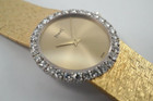 A fine vintage Piaget diamond bracelet watch in 18k yellow gold, crafted during the 1970s. The 25mm round and 5mm silhouette case houses 30 diamonds factory set bezel, approximately 1.20 carats, gold dial and dauphine hands. A beautiful accessory worn elegantly on the wrist for casual or formal wear.

Light scratch on crystal, 7 o’clock position.
Original dial, hands and crown. 
Case measures 25 x 25 mm, 5mm thick.
Piaget cal. 9P, 18 jewels mechanical winding. 
Sapphire crystal.
Serial# 151477 Movement# 6896xx
Piaget bracelet fits 6 1/4 inches or 16 cm approximate, links are removable.
16mm wide bracelet, tapers.
Modeled on a 6 inch wrist.