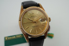 A finely preserved Rolex Date reference 15238 in 18k yellow gold, produced circa 1993. An incredible find of a 20 year award dedication watch, unpolished and turned a lovely patina orange peachy. Featuring 34mm round case with fluted bezel, champagne dial, gold applied beveled hour markers with lume end plots and baton hands with lume in middle, and date aperture. Paired with a Rolex black leather strap and its original gold plated buckle, this handsome time capsule piece would make an excellent addition to a collection.

Dial has small bubbles, patina’d case.
Case back has engraving.
Rolex NYC papers dated May 1993.
Original dial, hands and crown.
Case measures 34 x 43mm, 11.5mm thick.
Sapphire crystal. 
Rolex cal., automatic winding. Quick set date.
Serial# N1994xx
Rolex black leather strap.
Rolex gold plated buckle.
19mm lug width.
Modeled on 6 inch wrist.