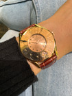 A vintage Universal Geneve automatic watch in 18k rose gold, crafted during the 1950s. Unusual and rare configuration of a 34.5mm dioramic disco volante case with female-style lugs and spring bars, an exaggerated bezel with engraved Arabic hour markers and date aperture located at 6 o’clock on bezel. Housing a rose-colored dial with faceted rose gold arrow marker and hands. Its profile measures 8mm, extended to 10mm including the domed crystal. This vintage accessory would make an excellent addition to vintage collection for its remarkable design. 

Minimal scratches, small nicks at 10 o’clock bezel, small chip of date aperture crystal.
Original dial, hands, and crown. 
Case measures 34.5 x 41 mm, 10mm thick.
Acrylic crystal. 
Universal Geneve cal. 138C, 17 jewels bumper automatic movement. 
Serial# 18113xx
Premium brown crocodile strap. 
18mm lug width.
Modeled on 6 inch wrist.