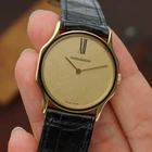 A wickedly cool Jaeger-LeCoultre from the 1980s that appears minimal at first glance, but reveals considerably more detail on closer inspection. The ultra-thin 18k yellow gold case has an unusual sculpted form, with gently concave sides flowing into long, tapered lugs. A fine black enamel accent circles the bezel, giving the warm gold case a sharp line of contrast.
The beautifully textured champagne dial with a soft, frosted appearance follows the same minimalist approach, interrupted only by a singular elongated black Roman numeral at 12 o’clock. Slim pointed gold hands appear almost suspended over the dial, meeting at a clean circular center without the usual visible central hardware. It is an exceptionally simple layout, but far from ordinary.
Powered by the Jaeger-LeCoultre caliber 895 manual-wind movement and finished with a JLC-signed crown. Fitted with a black JLC crocodile strap and JLC gold-plated buckle. A neo-vintage JLC with considerably more going on than first meets the eye.


Case Number: 9211-21
Serial Number: 1520xxx
Case: 18k yellow gold with black enamel bezel accent
Case Size: 30 × 35 mm; 5 mm thick
Dial: Textured champagne with elongated black Roman numeral at 12 o’clock
Movement: Jaeger-LeCoultre caliber 895, manual wind
Strap: JLC black crocodile
Buckle: JLC gold-plated buckle
Lug Width: 18 mm
Wrist Size: Fits up to approximately 7 inches
Modelled On: 6-inch wrist
Condition: Light wear shown
Service: Timing performed by our watchmaker
