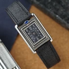 A late 1990s Cartier Tank Basculante in stainless steel, wonderfully constructed in a compact 22mm size. The dark grey patterned dial is contrasted by bright white stylized Arabic numerals and silvered sword-shaped hands, giving the watch a distinctive monochromatic look.
The Basculante's hinged case is the highlight of the design, allowing the watch head to pivot within its frame and turn completely over. It opens and closes smoothly and can remain upright within the frame. A blue cabochon accents the case, while the crown is cleverly concealed and accessed only when the watch is flipped from its usual position.
Powered by a quartz movement and fitted with a custom dark grey Babele leather strap secured by a Cartier stainless steel deployant clasp. An unusual interpretation of the Tank, with much of its appeal found in the ingenious case construction.

Watch Details
Reference: 2386
Case Number: 3514xxxx
Case: Stainless steel
Case Size: 22 × 32 mm; 6 mm thick
Dial: Dark grey patterned dial; white Arabic numerals
Movement: Quartz
Crystal: Sapphire
Strap: Custom dark grey Babele leather, adjustable
Lug Width: 17 mm
Clasp: Cartier stainless steel deployant
Wrist Size: Fits up to approximately 6 1/2 inches
Modelled On: 6-inch wrist
Condition: Light wear shown
Service: New battery installed