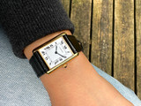 A fine preowned Cartier Tank Grains of Rice in 18k yellow gold, crafted during the 1990s. A special edition of the popular and enduring Tank model for its bracelet charmingly described as grain or beads of rice. The classic white Roman dial with blued steel hands paired with the bracelet serves a dressy look, alternatively a leather strap will tone it down  for more casual feel. Wonderfully drapes the wrist and is comfortable to wear, suitable for men or woman. Modeled on 6 inch wrist.

Light scratches and small nick on crystal. 
Original dial, hands and sapphire crown. 
Case measures 23.5 x 31 mm, 6 mm thick. 
Sapphire crystal. 
Cartier quartz movement. 
Serial# 810522xxx
Cartier bracelet has been previously fitted. Fits 6 1/2 inch or 17 cm approximate.
New non-Cartier black leather strap.
17.5 wide.