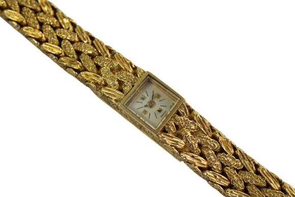 A fine vintage Vacheron Constantin watch in 18k yellow gold, crafted during the 1950s. The smallest of its kind, this wonderfully dainty watch serves as jewelry for its handcrafted meshed braid-like bracelet and tiny square 8mm white face containing gold squares and black hash minute marks, and gold sword-shaped hands. The bracelet’s motif can be seen from both sides and the winding is located on the case back as to not take away from its overall design. The jewelry clasp adds to the seamless bracelet look and comfort fit. Subtle enough for casual wear and elegant enough for dressy occasions.