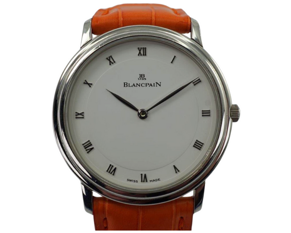 BRAND:                           Blancpain
MODEL:                           Villeret
CASE MATERIAL:           Stainless steel
CASE MEASURES:          34 x 38 mm
MOVEMENT:                   Mechanical
FUNCTIONS:                   Time 
CONDITION:                    Fine
See it in our eBay store.

A fine preowned Blancpain Villeret reference 0021-1127-55 in stainless steel, crafted during the 2000s. Wears well for a minimal look on the wrist with the classic white dial featuring diminutively elegant silver-toned Roman numeral markers and elongated hands contained within a stepped ultra-thin case with an orange leather strap as a fun pop of color. Would suit a variety of settings, wardrobes and wrist sizes. Modeled on size 6 inch wrist.

Light scratches. 
Original dial, hands and crown.
Case measures 34 x 38 mm, 5 mm thick.
Blancpain cal. 21, 18 jewels mechanical wind. 
Serial# 12xx
Sapphire crystal.
New Blancpain tangerine crocodile adjustable strap, fits 7 1/2 inch wrist.
Blancpain steel deployment. 
19 mm between lugs.
U.S. retail $8,300.