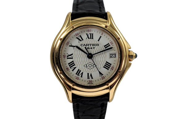 A very nice Cartier Panthere Cougar reference 1171-1 in 18k yellow gold, crafted in 1997. A special limited edition accessory commemorating 150 years of its inception in 1847, featuring a special dial with L heart C inside an inverted diamond, red numerals on sweep seconds, blued steel hands, glossy black Roman hour numerals, sapphire cabochon and date aperture at 3 o’clock position. Despite its diminutive 23mm case, the dial will garner a double take and wears quite comfortably on the wrist with its low profile.

Light scratches on case.
Original commemorative 1847 150th anniversary dial, blued steel hands and sapphire cabochon crown. 
Case measures 26 x 31mm, 6.5mm thick.
Cartier quartz movement. 
Serial# C283xx 
Sapphire crystal.
Cartier black crocodile strap (85% condition, approximate).
Cartier 18k yellow gold buckle. 
12mm lug width.
Modeled on 6 inch wrist.