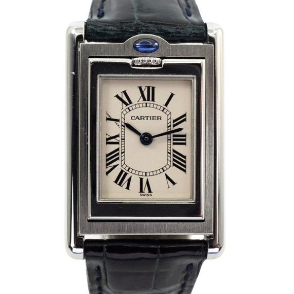 A nice preowned Cartier Basculante reference 2386 with Cartier papers, crafted circa 2001. This is a curious design modeled after their first Cabriolet model from 1932 for its intended functionality during physical activity, so that the crystal is protected, as such the crown placement is allocated to the 12 o’clock position with a horizontal blue oval cabochon charmingly sitting on top. The dial is the standard silvered dial with black Roman numeral markers and inner chemin de fer minute track, secret Cartier signature at 10 o’clock and blued-steel sword-shaped hands. The inner polished case housing said dial is configured into a swing frame, movable in either forward or reverse direction, revealing double C signatures on the inner case back and a smooth steel topper. While this function may not pertain to today’s needs, it is a fascinating detail that sets it apart from the regular Tank models and manages to sit relatively flush on the wrist.