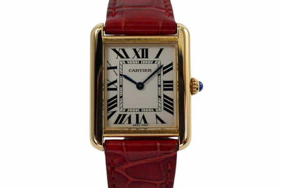A very nice Cartier Tank Solo reference 2743 in 18k yellow gold, crafted circa 2010. A classic piece from Cartier featuring 24.5mm rectangular case with rounded edges housing a silvered dial with black Roman numeral hour markers and inner minute track, steeled-blue sword-shaped hands and blue cabochon beaded crown. The red crocodile strap provides a complementary contrast with the yellow gold that would suit a variety of wardrobes.  

Original dial, hands and cabochon crown.
Case measures 24.5 x 31mm, 5.5mm thick.
Cartier cal., quartz movement. 
Case# 9500xxxX
Sapphire crystal.
Cartier red crocodile strap (80% condition approximate).
Cartier 18k tang buckle.
18mm lug width.
Modeled on 6 inch wrist.