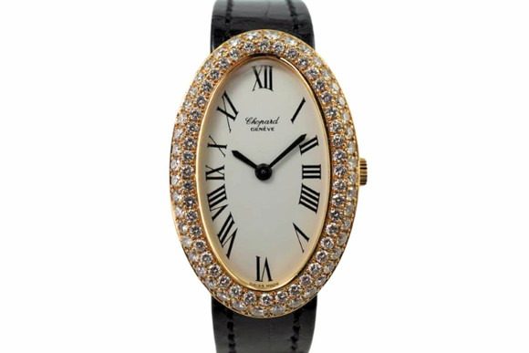 A fine preowned Chopard ladies oval watch in 18k yellow gold, crafted during the 1990s. Resembling the popular Baignoire aesthetic, features a 23mm oval case holding a double row of 90 full cut diamond factory set bezel, stamped LUC crown, housing a classic white dial with black Roman numeral hour markers and black-steeled sword-shaped hands. Outfitted with a like-new black crocodile strap with a charming oval-shape Chopard buckle. Its 7mm silhouette sits elegantly on the wrist from the slight curve of the case creating a delicate balance. Suitable for various occasions.  

Small scratches and slight tarnish.
Original dial, hands, and crown. 
2+ total carat weight factory diamonds, approximate.
Case measures 23 x 35 mm, 7mm thick.
Sapphire crystal. 
Serial# 2554xx
Chopard cal. 846, 18 jewels mechanical winding. 
Chopard black crocodile strap (95% condition approximate).
13mm lug width.
Modeled on 6 inch wrist.