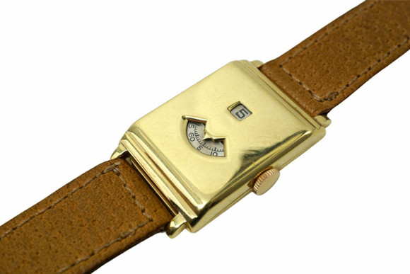 BRAND:                           Movado 
MODEL:                           Jump Hour
CASE MATERIAL:            18k yellow gold
CASE MEASURES:          25 x 40 mm
MOVEMENT:                   Mechanical  
FUNCTIONS:                   Digital time
CONDITION:                    Fine
See it in our eBay store.

A very rare Movado Jump Hour digital time in 18k yellow gold from the 1930s with solid gold hinged case. The case features two windows, one for the hour and one for the minutes, and is signed Movado. Comes with original dial and hands, crown was replaced long ago. We will include a new 18 mm brown leather strap and original period 18k buckle signed C&C. 750. This watch design is very eye catching and makes for a great piece to add to your collection.