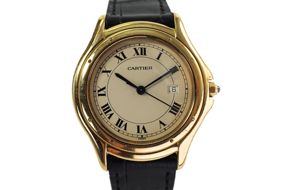 A fine preowned Cartier Cougar Panthere reference 887904 in 18k yellow gold , crafted during the 1990s. Features the standard white dial with a slight patina, black Roman numeral hours and thin outer minute railroad track, date aperture in place of the 3 o’clock, and blued-steel sword-shaped hands. The 32mm round case will suit a man or woman’s wrist, paired with a black leather strap suiting a variety of settings sitting comfortably with its 6 mm silhouette. 

Slight tarnish and scratches.
Original dial, hands and Cartier crown.
Sapphire crystal.
Case measures 32 x 38mm, 6 mm thick.
Cartier quartz jeweled movement.
Serial# 1404xxx
New premium non-Cartier black leather strap.
Cartier plated buckle.
16mm lug width.