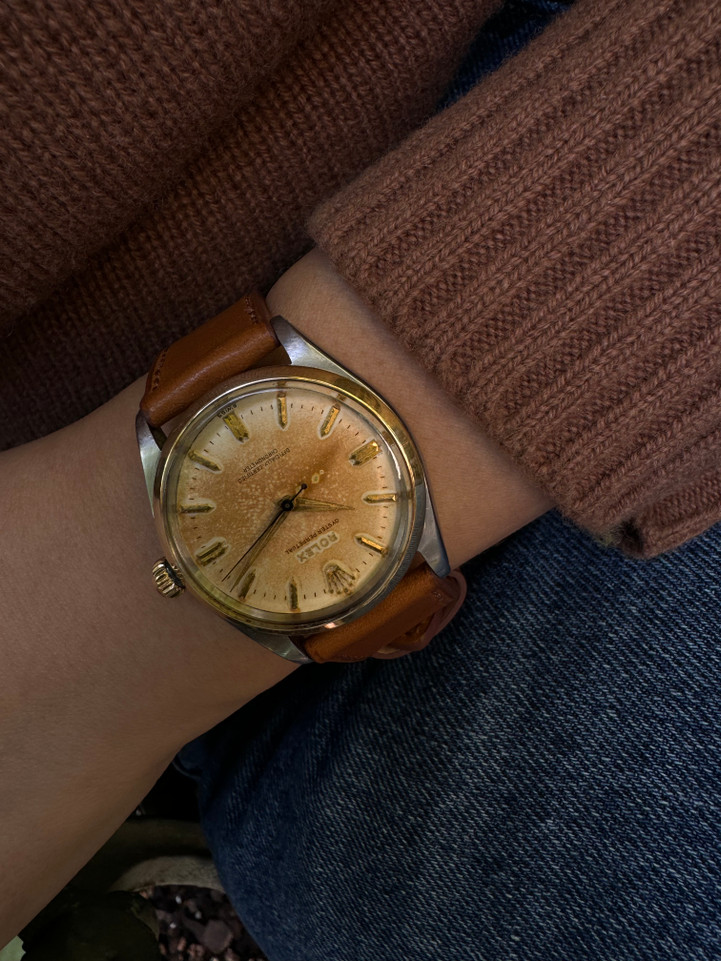 A very nice vintage Rolex Oyster Perpetual reference 6564, crafted circa 1957. An impressive statement for the wearer’s wrist with the striking tropical patina dial and gold raised hour markers, flashing vividly in the light. The movement has a neat butterfly cut out movement, a little fun fact for the wearer to appreciate. Suitable for various occasions. Modeled on a 6 inch wrist. 

Dial and hands show significant patina.
Original dial, hands and crown. 
Case measures 34 x 39.5 mm.
Rolex cal. 1030, 25 jewel automatic.
Serial# 
Acrylic crystal.
New premium non-Rolex brown leather strap.
19 mm between lugs.