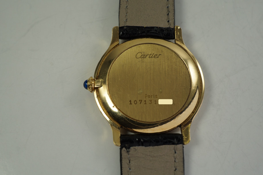 Cartier Round Paris 18k yellow gold mechanical wind dates 1990's modern pre owned for sale houston fabsuisse