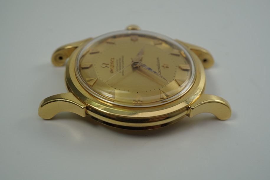 A fine vintage Omega Constellation reference 2852 SC in 18k yellow gold, crafted in the late 1950s. Case and movement exhibit beautifully preserved craftsmanship and rarely seen, most likely unpolished with its original finish. Pie pan gold tonal dial is mint condition and glistens in the light, attracting attention to the wearer’s wrist. Suitable for men or women for a variety of occasions. Modeled on 6 inch wrist.

Unpolished, original finish. 
Original Pie Pan dial, hands and crown. 
Case measures 35 x 45 mm.
Omega cal. 505, 24 jewels automatic. 
Serial# 15655xxx Case# 2398xx
Acrylic crystal.
New non-Omega premium tan leather strap. 
18mm lug width.