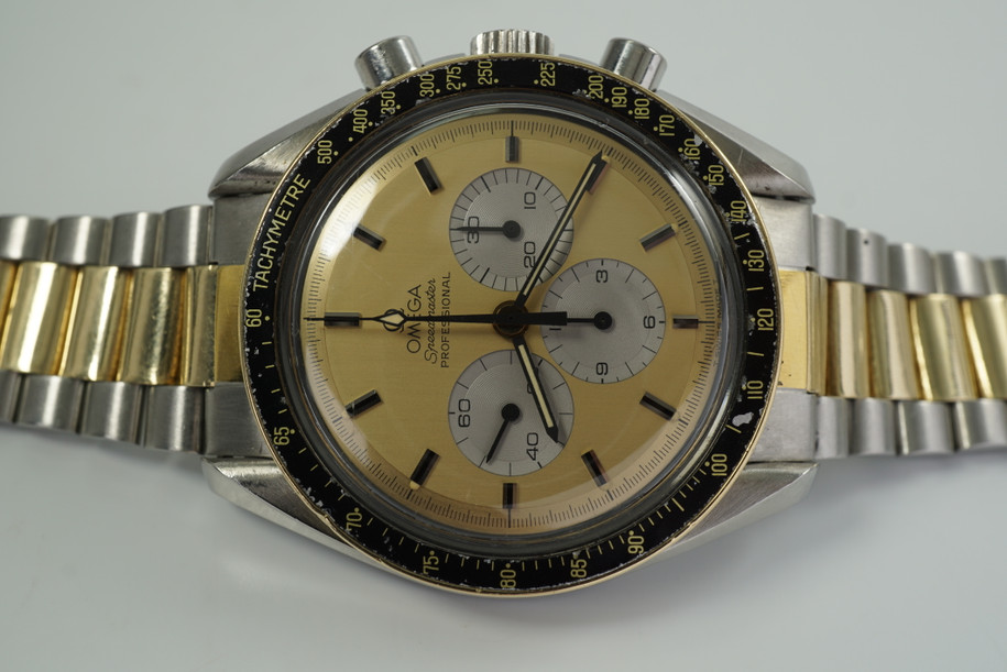 A nice vintage Omega Speedmaster Professional reference DD145022 in stainless steel and 14k yellow gold, crafted between 1982-83. A rare two-tone configuration find, produced in small quantities in the 1980s. Oversized 42 mm round case with tapered lugs holds a black bezel with gold tachymeter scale. Champagne dial with black and steel baton hour markers with lume plots, outer black minute hashes, and sword-shaped lume hands. The 3 silver registers contrast beautifully against the gilt dial complementing the two-tone presentation, and its bracelet containing a single deployant closure. This special watch is the particular wearer who is appreciative of the historical details it presents.