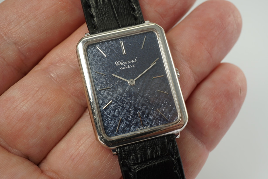 A vintage Chopard reference 2024 in 18k white gold crafted during the 1980s, featuring an attractive blue textured hatch mark style dial that catches the eye, with white gold baton markers as a beautifully complementing contrast.  ready to be adorned by the wearer who appreciates an understated yet elegant timepiece. This piece rests flatter on the wrist making it lightweight and non-cumbersome to use. Although it was designated as a men’s watch, it would suit a woman's wrist for a variety of occasions. 

Light scratches. 

6 mm thick case.

Chopard cal. ETA 2512, 17 Jewels mechanical winding. 

Case# 50496

Sapphire crystal. 

New non-Chopard premium black leather strap.

16 mm between lugs. 

Modeled on 6 inch wrist.