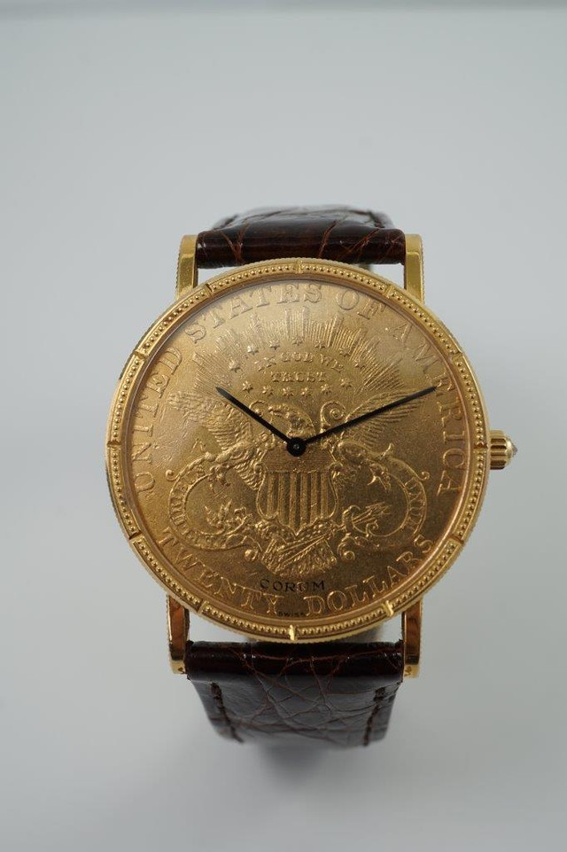 BRAND:                            Corum 
MODEL:                            $20 Liberty
CASE MATERIAL:            18k yellow gold 
CASE MEASURES:          35.5 x 42 mm
MOVEMENT:                     Mechanical winding
FUNCTIONS:                    Time 
CONDITION:                     Fine
See it in our eBay store.
A fine preowned Corum 20 Dollar Liberty Coin watch in 18k yellow gold, crafted during the 2000s. A collectible piece to add to your collection, the back bears the year 1878. Makes a lovely golden statement on the wrist for a variety of settings. Modeled on a 6 inch wrist. 
Light scratches.
Original dial, hands, diamond crown. 
Case measures 35.5 x 42 mm, 5 mm thick. 
Corum cal., 18 jewels mechanical winding.
Serial# 592501
New non-Corum brown leather strap.
Corum 18k gold buckle.
20 mm between lugs.