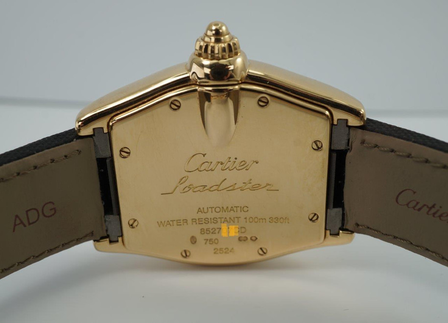 BRAND:                            Cartier
MODEL:                            Roadster
CASE MATERIAL:            18k yellow gold
CASE MEASURES:          36 x 44 mm
MOVEMENT:                     Automatic
FUNCTIONS:                    Time and date 
CONDITION:                     Very good
See it in our eBay store.
A fine Cartier Roadster in 18k yellow gold reference 2524, crafted in the 2000s. A classic model with silver/white Roman dial, lume hands and gold screw down crown. Great size fit without an overwhelming profile, suitable for various occasions. Modeled on a 6 inch wrist. 

Scratches on case. 
Original silver/white Roman dial, lume hands and gold Cartier screw down crown. 
Sapphire crystal.
Cartier caliber, highly jeweled automatic winding. 
Serial# 8527xxxD
Cartier black coated canvas adjustable strap.
Cartier 18k gold deployment buckle.
19 mm between flexible lugs.