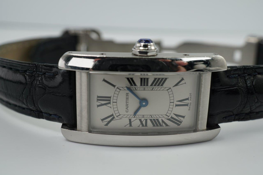 BRAND:                           Cartier
MODEL:                           Tank Americaine
CASE MATERIAL:            Stainless steel 
CASE MEASURES:          19 x 35 mm
MOVEMENT:                     Quartz
FUNCTIONS:                    Time
CONDITION:                     Very good
See it in our eBay store.
A fine preowned Cartier Tank Americaine reference 3970 in stainless steel, crafted circa 2020.  Classic minimal style with the white dial in stainless steel case and black leather strap that would suit a variety of occasions. Modeled on a 6 inch wrist. 

Light scratches and scuffs.
Case measures 19 x 35, 7 mm thick. 
Cartier caliber quartz movement.
Serial# 1049xxxX
Carter black alligator strap (85% condition).
Cartier steel deployment buckle.
13 mm between lugs.