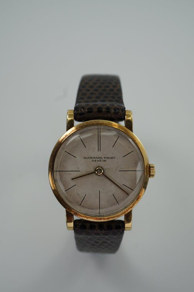 BRAND:                           Audemars Piguet
MODEL:                           Round
CASE MATERIAL:            18k yellow gold
CASE MEASURES:          23.5 x 28.5 mm
MOVEMENT:                    Mechanical winding
FUNCTIONS:                    Time
CONDITION:                     Fine
See it in our eBay store.

A very rare vintage Audemars Piguet in 18k yellow gold, crafted circa 1962. Charming little accessory that adopts a quiet presence on the wrist with its small round case. It may not make an impressive statement but for those who admire Audemars Piguet’s craftsmanship will recognize the rarity in this vintage model. Suitable for all occasions and simply put, nearly one of a kind found on the market. Modeled on a 6 inch wrist. 

Scratches, tarnishing.
Original dial, hands and crown. 
Case measures 23.5 x 28.5 mm, 12mm case.
Movement# 870xx
Acrylic crystal.
New non-Audemars brown lizard strap.
Signed Audemars Piguet 18k gold buckle.
12 mm between lugs.