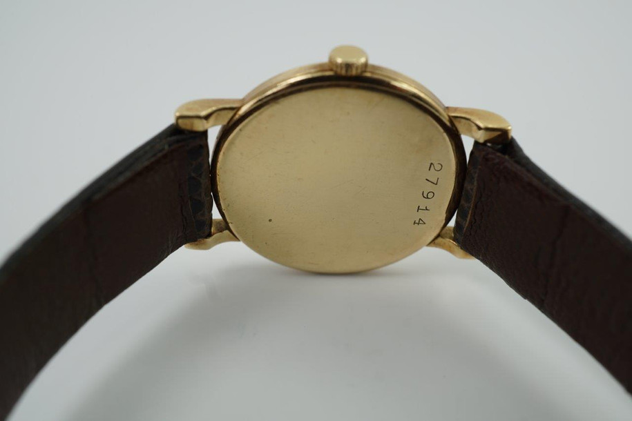 BRAND:                           Audemars Piguet
MODEL:                           Round
CASE MATERIAL:            18k yellow gold
CASE MEASURES:          23.5 x 28.5 mm
MOVEMENT:                    Mechanical winding
FUNCTIONS:                    Time
CONDITION:                     Fine
See it in our eBay store.

A very rare vintage Audemars Piguet in 18k yellow gold, crafted circa 1962. Charming little accessory that adopts a quiet presence on the wrist with its small round case. It may not make an impressive statement but for those who admire Audemars Piguet’s craftsmanship will recognize the rarity in this vintage model. Suitable for all occasions and simply put, nearly one of a kind found on the market. Modeled on a 6 inch wrist. 

Scratches, tarnishing.
Original dial, hands and crown. 
Case measures 23.5 x 28.5 mm, 12mm case.
Movement# 870xx
Acrylic crystal.
New non-Audemars brown lizard strap.
Signed Audemars Piguet 18k gold buckle.
12 mm between lugs.