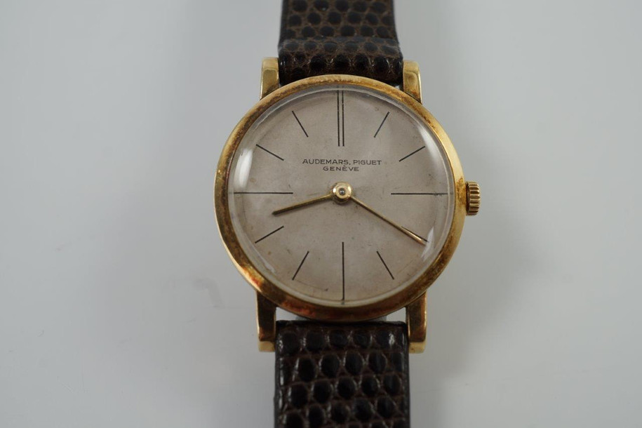 BRAND:                           Audemars Piguet
MODEL:                           Round
CASE MATERIAL:            18k yellow gold
CASE MEASURES:          23.5 x 28.5 mm
MOVEMENT:                    Mechanical winding
FUNCTIONS:                    Time
CONDITION:                     Fine
See it in our eBay store.

A very rare vintage Audemars Piguet in 18k yellow gold, crafted circa 1962. Charming little accessory that adopts a quiet presence on the wrist with its small round case. It may not make an impressive statement but for those who admire Audemars Piguet’s craftsmanship will recognize the rarity in this vintage model. Suitable for all occasions and simply put, nearly one of a kind found on the market. Modeled on a 6 inch wrist. 

Scratches, tarnishing.
Original dial, hands and crown. 
Case measures 23.5 x 28.5 mm, 12mm case.
Movement# 870xx
Acrylic crystal.
New non-Audemars brown lizard strap.
Signed Audemars Piguet 18k gold buckle.
12 mm between lugs.