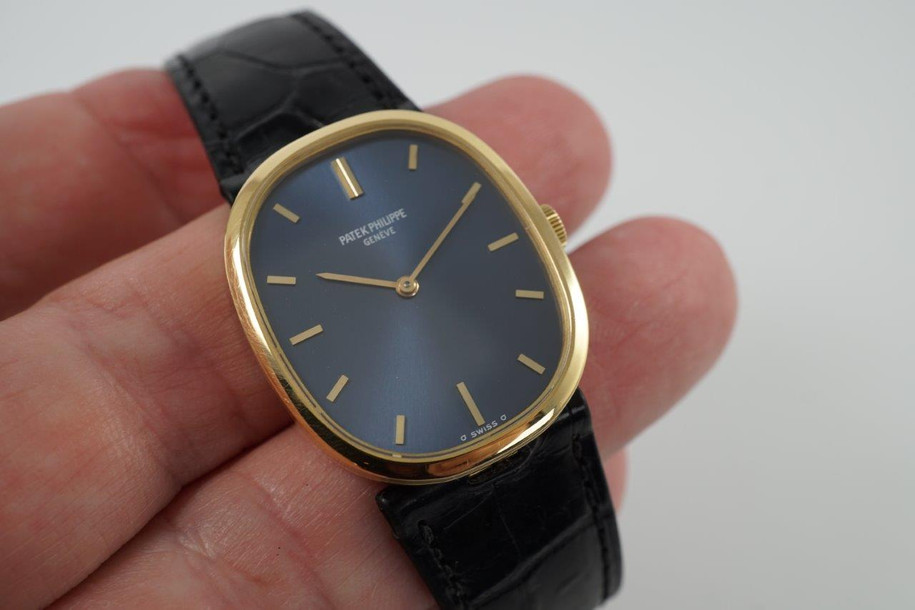 BRAND:                           Patek Philippe
MODEL:                           Ellipse
CASE MATERIAL:            18k yellow gold
CASE MEASURES:          27 x 32 mm
MOVEMENT:                   Mechanical
FUNCTIONS:                   Time 
CONDITION:                    Fine
See it in our eBay store.

A fine vintage Patek Phillipe 3548 Ellipse in 18k yellow gold, crafted during the 1970s. Its charm lies in the oval shape seen in the case, the theme extending to the buckle and strap end. Features a beautiful sunburst blue Patek sigma dial with gold hands, and paired with a black crocodile strap. Ideal for a variety of settings and outfits. Modeled on 6 inch wrist. 

Light scratches. 
Original blue and gold Patek sigma dial, hands and crown.
Case measures 27 x 32 mm, 6 mm thick.
Patek cal. 23-300, 18 jewels mechanical winding.
2 seals of Geneva. 
Sapphire crystal. 
Case# 2717xxx Movement# 12143xx
Patek black crocodile strap (75% condition approximate).
Patek 18k gold buckle. 
19mm between lugs.
