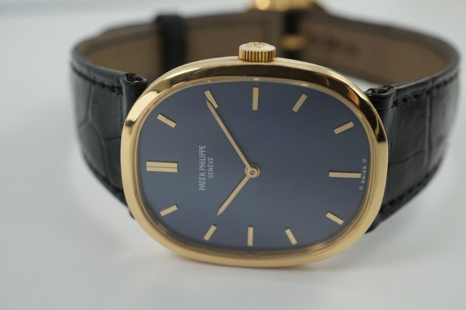BRAND:                           Patek Philippe
MODEL:                           Ellipse
CASE MATERIAL:            18k yellow gold
CASE MEASURES:          27 x 32 mm
MOVEMENT:                   Mechanical
FUNCTIONS:                   Time 
CONDITION:                    Fine
See it in our eBay store.

A fine vintage Patek Phillipe 3548 Ellipse in 18k yellow gold, crafted during the 1970s. Its charm lies in the oval shape seen in the case, the theme extending to the buckle and strap end. Features a beautiful sunburst blue Patek sigma dial with gold hands, and paired with a black crocodile strap. Ideal for a variety of settings and outfits. Modeled on 6 inch wrist. 

Light scratches. 
Original blue and gold Patek sigma dial, hands and crown.
Case measures 27 x 32 mm, 6 mm thick.
Patek cal. 23-300, 18 jewels mechanical winding.
2 seals of Geneva. 
Sapphire crystal. 
Case# 2717xxx Movement# 12143xx
Patek black crocodile strap (75% condition approximate).
Patek 18k gold buckle. 
19mm between lugs.