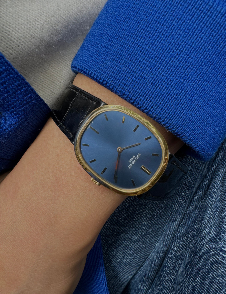 BRAND:                           Patek Philippe
MODEL:                           Ellipse
CASE MATERIAL:            18k yellow gold
CASE MEASURES:          27 x 32 mm
MOVEMENT:                   Mechanical
FUNCTIONS:                   Time 
CONDITION:                    Fine
See it in our eBay store.

A fine vintage Patek Phillipe 3548 Ellipse in 18k yellow gold, crafted during the 1970s. Its charm lies in the oval shape seen in the case, the theme extending to the buckle and strap end. Features a beautiful sunburst blue Patek sigma dial with gold hands, and paired with a black crocodile strap. Ideal for a variety of settings and outfits. Modeled on 6 inch wrist. 

Light scratches. 
Original blue and gold Patek sigma dial, hands and crown.
Case measures 27 x 32 mm, 6 mm thick.
Patek cal. 23-300, 18 jewels mechanical winding.
2 seals of Geneva. 
Sapphire crystal. 
Case# 2717xxx Movement# 12143xx
Patek black crocodile strap (75% condition approximate).
Patek 18k gold buckle. 
19mm between lugs.