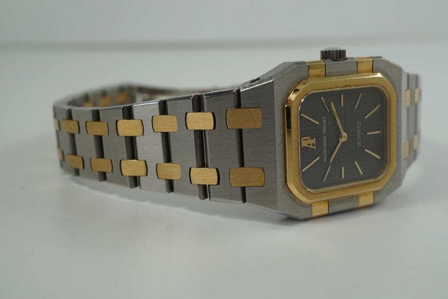 A fine Audemars Piguet Royal Oak in 18k yellow gold and stainless steel, crafted during the 1980s. The smaller rectangular case with the dark grey tapestry dial provides a minimal look, elevated by the gold accents beautifully catching the light. Perfect for casual or dressy affairs, and  wears flush on the wrist for a comfort fit. Modeled on 6 inch wrist. 

Original brushed finish on case and bracelet.

6mm thick case.

Audemars cal. jeweled quartz.

Serial# B60xxx

Audemars bracelet fits 5 7/8 inches or 15cm approximate.

18mm lug width. 

A new battery has been installed by our watchmaker.