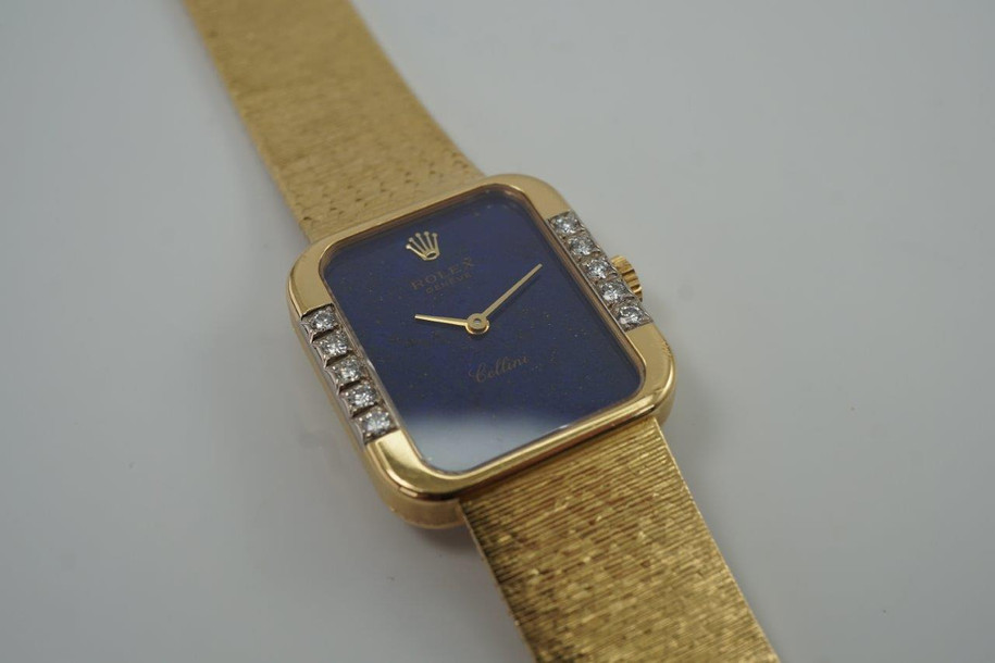 A fine vintage Rolex bracelet watch reference 4628 in 18k yellow gold, crafted circa 1985. A beautiful accessory featuring a gorgeous lapis dial with hints of pyrite peeking through radiates vividly in the light, and flanked by diamonds meticulously set on white gold seamlessly transfiguring into the yellow gold. Its 5.5mm rectangular profile provides an overall lightweight feel and the bracelet drapes the wrist comfortably. Suitable for all dress occasions. Modeled on 6 inch wrist.

Light scratches.
Original factory lapis dial, hands and crown.
Factory diamond set.
Case measures 23 x 25 mm, 5.5 mm thick. 
Rolex cal. 1601, 19 jewels mechanical winding.
Serial# 8833xxx Case# 793877
Sapphire crystal. 
Rolex bracelet fits 6 3/4 inches or 17.5cm, approximately.
15mm taper.
Weight 57.8 grams.