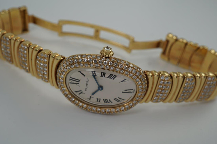 BRAND:                          Cartier
MODEL:                          Baignoire
CASE MATERIAL:           18k yellow gold and diamonds
CASE MEASURES:          22.5 x 30.5 mm
MOVEMENT:                   Quartz
FUNCTIONS:                   Time
CONDITION:                    Fine
See it in our eBay store.

A fine preowned Cartier Baignoire reference 3710 in 18k yellow gold, crafted during the 1980s. A current popular model with a distinctive added detail of the interchanging diamond settings and gold bracelet. Brilliant diamond set bezel and diamond crown encases an off white dial, blue steeled hands and black Roman numerals with hidden Cartier hallmark at 10 o’clock. The bracelet can be converted for a leather strap with ease for a more casual toned down look. Will certainly draw attention to the wearer’s wrist, wearing comfortably with either alternative.  

Light scratches on crystal. 
Original dial, hands and sapphire crown. 
Factory diamond set bezel and bracelet.
Case measures 22.5 x 30.5 mm, 6.5 mm thick. 
Acrylic crystal. 
Cartier quartz movement. 
Serial# 8057xxx
Cartier diamond bracelet fits 5 7/8 inches or 14.5 cm, approximately. Can be sized down.
New non-Cartier black leather strap.
13 lug width.
Modeled on 6 inch wrist.