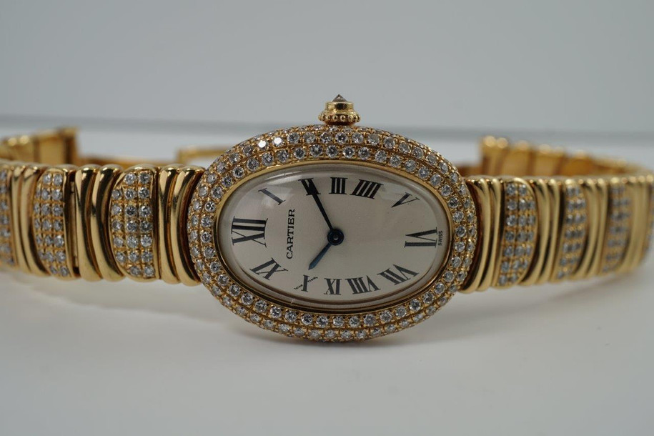 BRAND:                          Cartier
MODEL:                          Baignoire
CASE MATERIAL:           18k yellow gold and diamonds
CASE MEASURES:          22.5 x 30.5 mm
MOVEMENT:                   Quartz
FUNCTIONS:                   Time
CONDITION:                    Fine
See it in our eBay store.

A fine preowned Cartier Baignoire reference 3710 in 18k yellow gold, crafted during the 1980s. A current popular model with a distinctive added detail of the interchanging diamond settings and gold bracelet. Brilliant diamond set bezel and diamond crown encases an off white dial, blue steeled hands and black Roman numerals with hidden Cartier hallmark at 10 o’clock. The bracelet can be converted for a leather strap with ease for a more casual toned down look. Will certainly draw attention to the wearer’s wrist, wearing comfortably with either alternative.  

Light scratches on crystal. 
Original dial, hands and sapphire crown. 
Factory diamond set bezel and bracelet.
Case measures 22.5 x 30.5 mm, 6.5 mm thick. 
Acrylic crystal. 
Cartier quartz movement. 
Serial# 8057xxx
Cartier diamond bracelet fits 5 7/8 inches or 14.5 cm, approximately. Can be sized down.
New non-Cartier black leather strap.
13 lug width.
Modeled on 6 inch wrist.