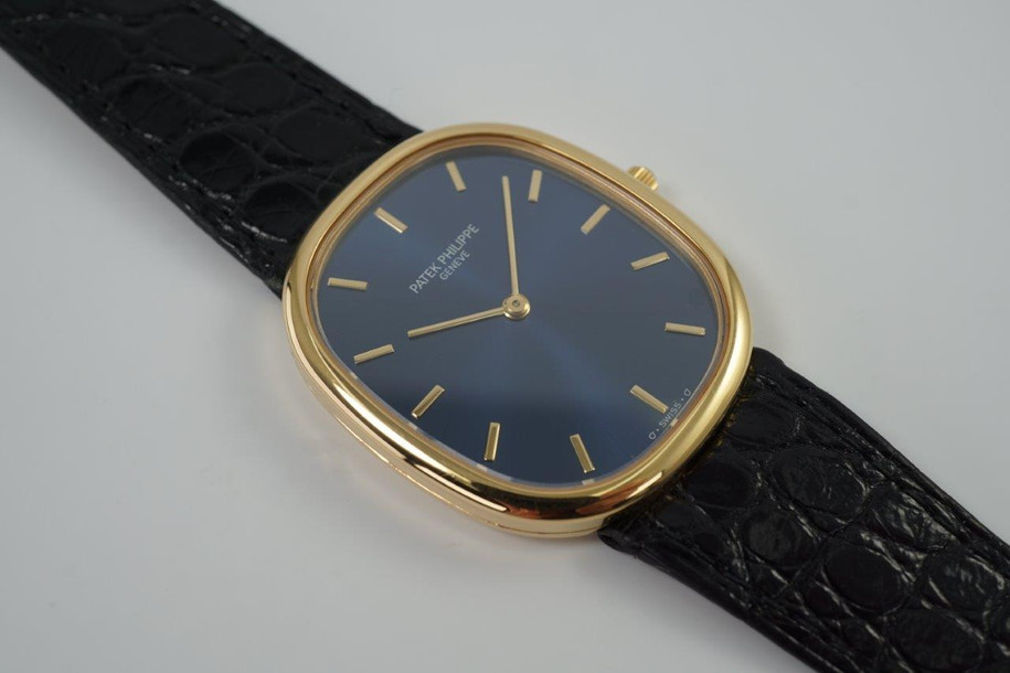 A fine preowned Patek Philippe Golden Ellipse in 18k yellow gold, crafted during the 2000s. A popular model from Patek for its perfectly proportionately oval case encasing a blue sunburst dial that glistens in the light beautifully with the shiny gold hour markers and hands. Paired with a black alligator strap for a casual and comfortable feel, with buckle that replicates the oval motif. 

Minimal scratches. 
Original blue sunburst dial, gold markers/hands and Patek crown. 
Case measures 31 x 36 mm, 6mm thick. 
Patek cal. 240, automatic winding.
Sapphire crystal. 
Patek Philippe black alligator strap (80% condition). 
Patek Ellipse 18k buckle 
20mm lug width. 
Modeled on 6 inch wrist.