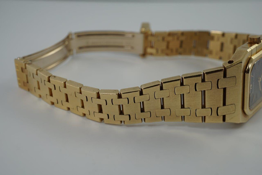 A very nice vintage Audemars Piguet Royal Oak in 18k yellow gold, crafted from the mid to late 1980s. The gold hours, hands and AP hallmark vividly stand out against the dark grey tapisserie dial in the light, complementing the boldness of the square rectangular case and bracelet. A lovely everyday piece that wears comfortably on the wrist with a thin profile and closure. 

Original finish shows normal wear due to use. 
Original tapisserie dial, gold hands and gold crown. 
Case measures 25 x 33 mm. 
AP cal. 2502, 7 Jewel quartz movement.
Serial# B604xx Movement# 213740 
Sapphire crystal. 
Original Audemars bracelet fits 6 1/8 inch or 15.5cm approximate.
18mm lug width. 
Modeled on 6 inch wrist.