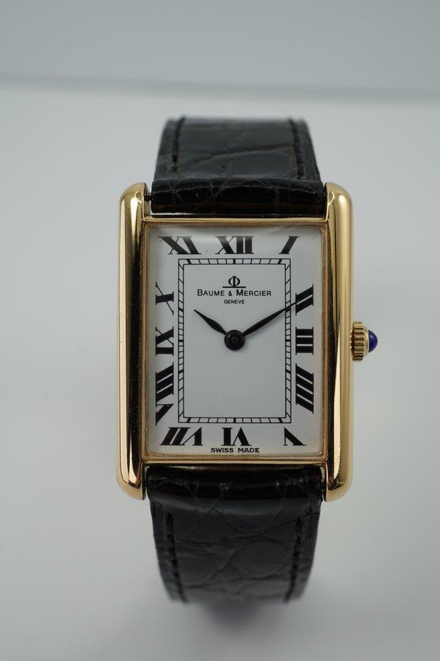 very nice preowned Piaget watch in 18k yellow gold reference 8035, crafted during the 1990-2000s. A classic configuration of understated gold round smooth case, white dial and gold applied hours and Roman numerals. This piece will take you from executive look to a casual occasion, featuring an ultra-thin profile and paired with a black strap. Suitable for men or women.

Minimal scratches. 
Original dial, hands and crown.
Case measures 32.5 x 35 mm, 4.5mm thick. 
Piaget cal. 858P quartz movement. 
Case# 594500 Movement# 9901021 
Sapphire crystal. 
Piaget black crocodile strap (80% condition approximate).
Piaget 18k gold buckle.
17mm lug width.