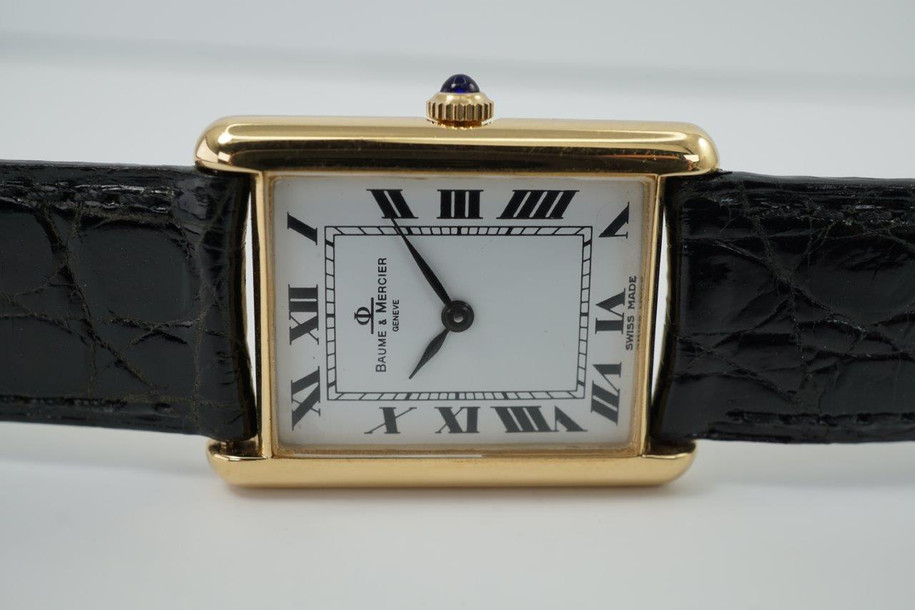 very nice preowned Piaget watch in 18k yellow gold reference 8035, crafted during the 1990-2000s. A classic configuration of understated gold round smooth case, white dial and gold applied hours and Roman numerals. This piece will take you from executive look to a casual occasion, featuring an ultra-thin profile and paired with a black strap. Suitable for men or women.

Minimal scratches. 
Original dial, hands and crown.
Case measures 32.5 x 35 mm, 4.5mm thick. 
Piaget cal. 858P quartz movement. 
Case# 594500 Movement# 9901021 
Sapphire crystal. 
Piaget black crocodile strap (80% condition approximate).
Piaget 18k gold buckle.
17mm lug width.