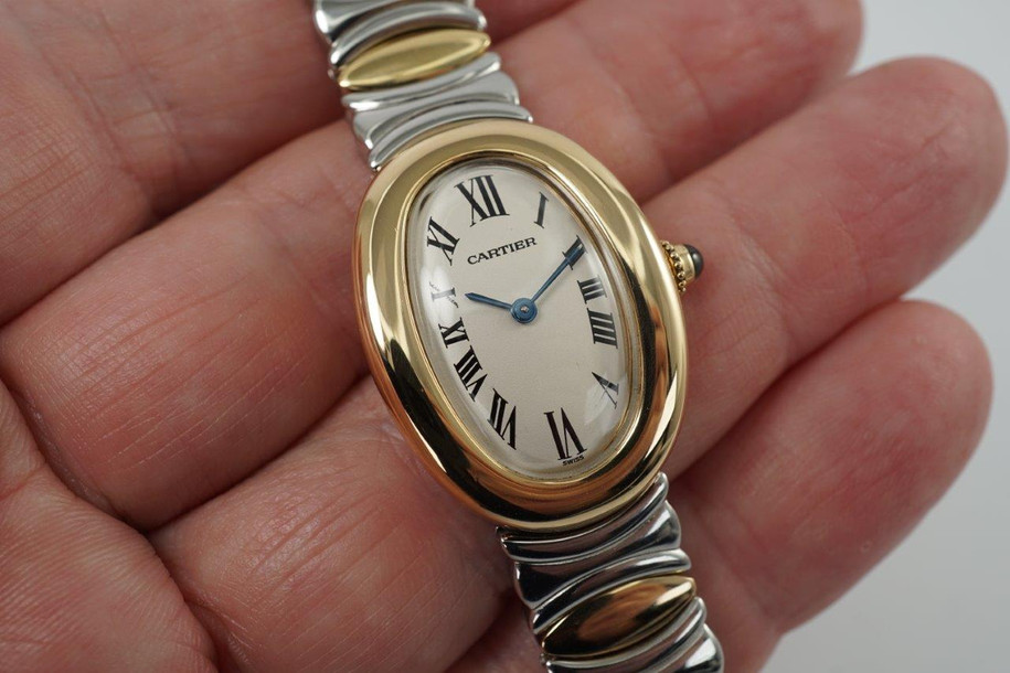 A fine preowned Cartier Baignoire reference W15045D8 in 18 yellow gold and stainless steel, crafted during the 2000s. A wonderful design with an attractive smooth oval case, featuring the classic off-white dial, black Roman numerals, blued steel hands, and blue sapphire crown. This versatile piece can be comfortably worn with its steel and gold Casque D'Or bracelet with hidden clasp, or alternatively with a black leather strap adopting a more casual feel. 

Minimal scratches. 
Original dial, hands and crown.
Case measures 22.5 x 31 mm, 7mm thick. 
Carter quartz movement. 
Serial# 8057xxx-42xx
Acrylic crystal, light scratches.
Cartier gold and steel bracelet, fits 6 3/4 inches or 17.3cm approximately.
13mm lug width.