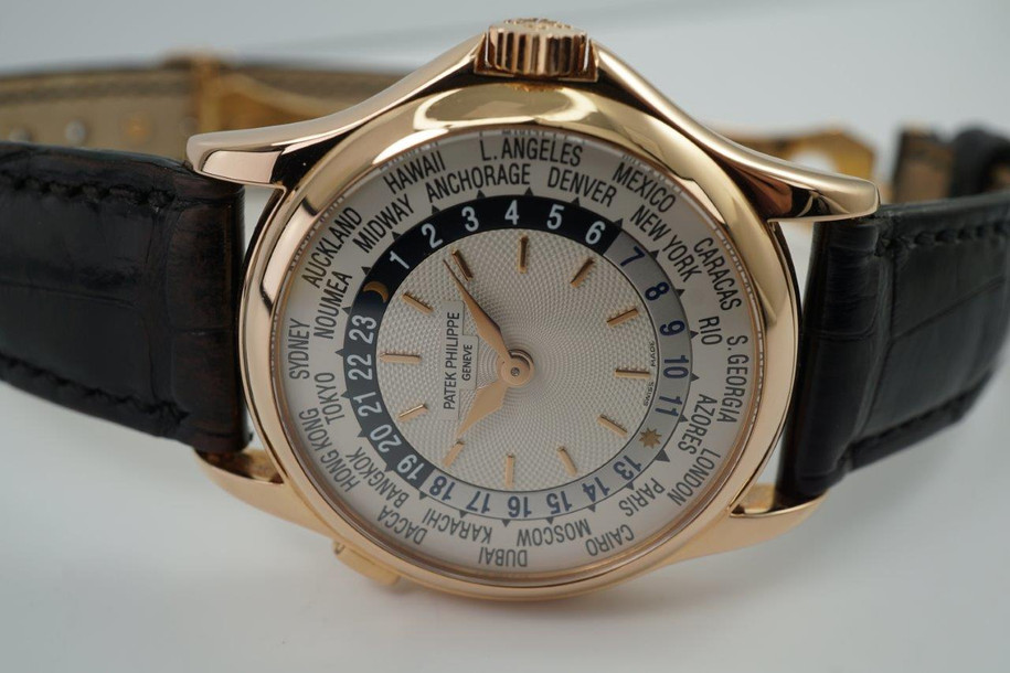 A fine Patek Philippe World Time reference 5110R in 18k rose gold, crafted during the 2000s. A impressive accessory featuring a silver guilloche dial engine turned sunburst center dial with rose gold applied baton hour indexes and hands, 24-hour ring with alternating silver and navy colored day and night indication. Perimeter disc rotates 24 time zones with their respective cities with the click of a button, and shoulders to protect the signed crown and exhibition back. Paired with a black crocodile strap and signature deployment buckle. 

Light scratches. 
Original guilloche dial, gold hands and Patek crown. 
Case measures 37 x 46mm, 10mm thick.
Patek cal. 240/188, 33 jewels automatic.
Case# 42363xx Movement# 3212xxx
Sapphire crystal.
Patek black crocodile strap (75% condition approximate).
Patek 18k rose gold deployment strap.
20mm lug width.
Modeled on 6 inch wrist.