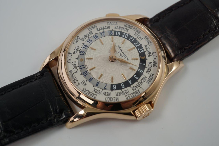 A fine Patek Philippe World Time reference 5110R in 18k rose gold, crafted during the 2000s. A impressive accessory featuring a silver guilloche dial engine turned sunburst center dial with rose gold applied baton hour indexes and hands, 24-hour ring with alternating silver and navy colored day and night indication. Perimeter disc rotates 24 time zones with their respective cities with the click of a button, and shoulders to protect the signed crown and exhibition back. Paired with a black crocodile strap and signature deployment buckle. 

Light scratches. 
Original guilloche dial, gold hands and Patek crown. 
Case measures 37 x 46mm, 10mm thick.
Patek cal. 240/188, 33 jewels automatic.
Case# 42363xx Movement# 3212xxx
Sapphire crystal.
Patek black crocodile strap (75% condition approximate).
Patek 18k rose gold deployment strap.
20mm lug width.
Modeled on 6 inch wrist.