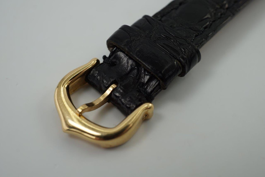 A very nice Cartier Panthere Cougar reference 1171-1 in 18k yellow gold, crafted in 1997. A special limited edition accessory commemorating 150 years of its inception in 1847, featuring a special dial with L heart C inside an inverted diamond, red numerals on sweep seconds, blued steel hands, glossy black Roman hour numerals, sapphire cabochon and date aperture at 3 o’clock position. Despite its diminutive 23mm case, the dial will garner a double take and wears quite comfortably on the wrist with its low profile.

Light scratches on case.
Original commemorative 1847 150th anniversary dial, blued steel hands and sapphire cabochon crown. 
Case measures 26 x 31mm, 6.5mm thick.
Cartier quartz movement. 
Serial# C283xx 
Sapphire crystal.
Cartier black crocodile strap (85% condition, approximate).
Cartier 18k yellow gold buckle. 
12mm lug width.
Modeled on 6 inch wrist.