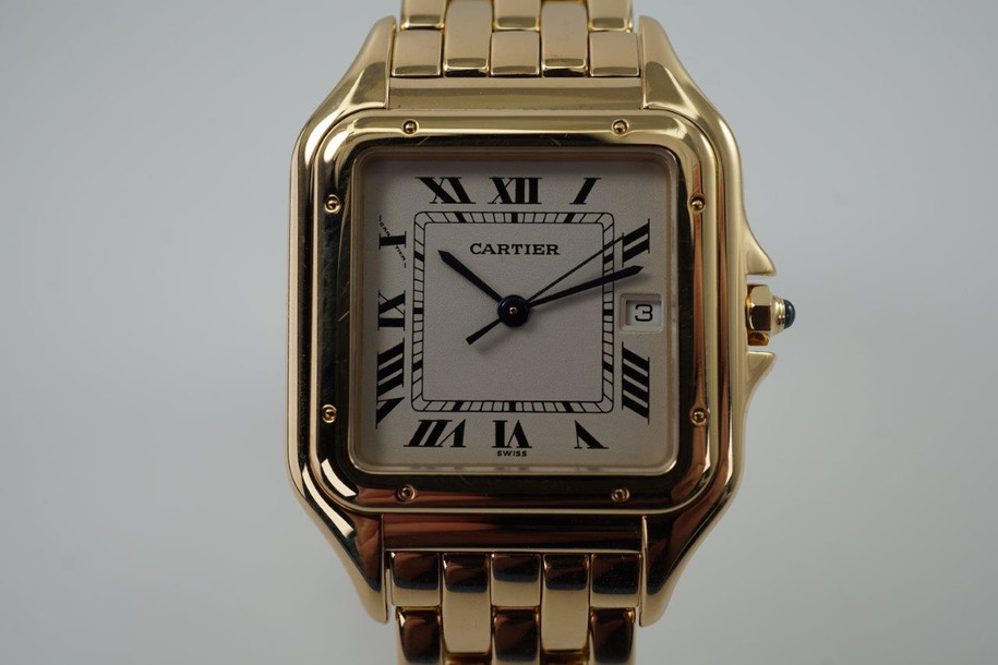 A fine Cartier Panthere reference 1060 in 18k yellow gold, crafted during the 1990s. In near mint condition, this accessory features a white dial, black Roman numerals and chemin de fer, blued steel sword hands, date aperture and inconspicuous written Cartier at 10 o’clock with a blue spinel cabochon. Wears as jewelry for its beautiful gold bracelet with hidden clasp and low silhouette square case for a comfort fit. From day to night, suitable for all dress occasions for either a man or woman. 

Original box shows interior wear. 
Original dial, hands and crown. 
Case measures 28 x 38mm, 6mm thick.
Sapphire crystal. 
Serial# CC165xxx
Cartier 18k yellow gold bracelet, full size and tight bracelet with no stretch (fits 7 1/4 inch or 18.4 cm). 
15mm lug width.
Modeled on a 6 inch wrist.