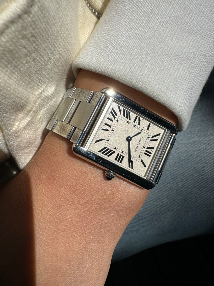 A very nice preowned Cartier Tank Solo reference 3169 in stainless steel, crafted circa 2015. Iterations currently offered in Cartier’s line of offerings, features the standard silvered grained dial with black Roman numerals and chemin de fer, blued steel sword shape hands, and blue spinel cabochon. Can be worn with its steel bracelet for everyday wear, or alternate for the taupe leather strap for a more casual feel. Suitable for men or women.

Minimal scratches.
Original dial, hands and crown. 
Case measures 27.5 x 34.5mm, 5.5mm thick.
Cartier quartz movement.
Sapphire crystal.
Serial# 9110xxxX
Cartier steel bracelet, measures 6 1/4 inches.
Premium non-Cartier taupe leather strap.
20 mm lug width. 
Modeled on a 6 inch wrist.