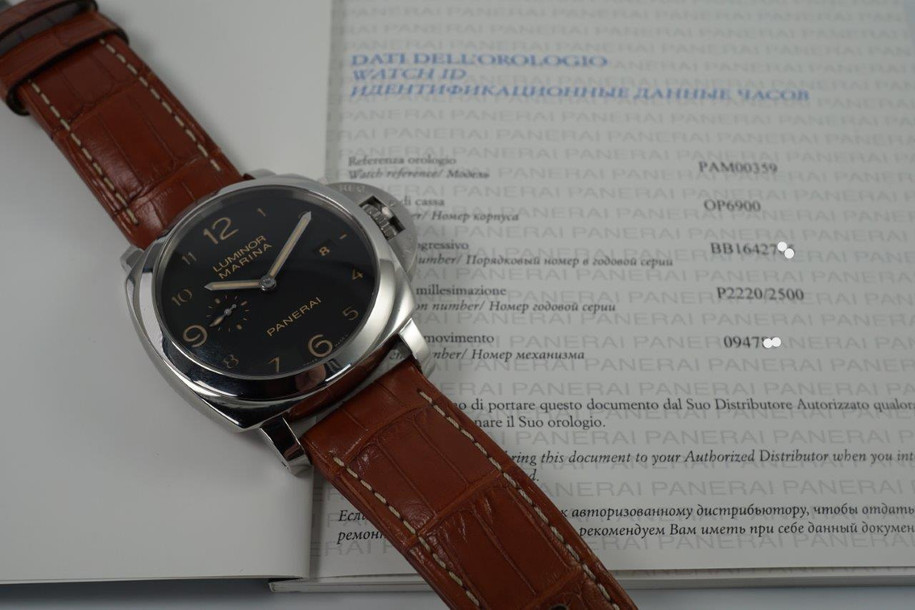 A fine preowned Panerai Luminor Marina 1950 reference PAM 00359 with wooden box and books originally sold from Ginza Boutique Japan, crafted circa 2014. A bold piece fitting for a large wrist, features a sandwich black dial with large lume Arabic numeral hours and sword-shaped hands, subsidiary dial and date aperture, surrounded by a 45 mm steel case with elevated 18 mm silhouette and exhibition case back. Self-winding for 3 days. Suitable for casual wear.