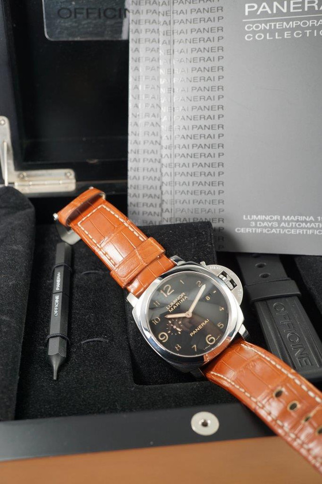A fine preowned Panerai Luminor Marina 1950 reference PAM 00359 with wooden box and books originally sold from Ginza Boutique Japan, crafted circa 2014. A bold piece fitting for a large wrist, features a sandwich black dial with large lume Arabic numeral hours and sword-shaped hands, subsidiary dial and date aperture, surrounded by a 45 mm steel case with elevated 18 mm silhouette and exhibition case back. Self-winding for 3 days. Suitable for casual wear.