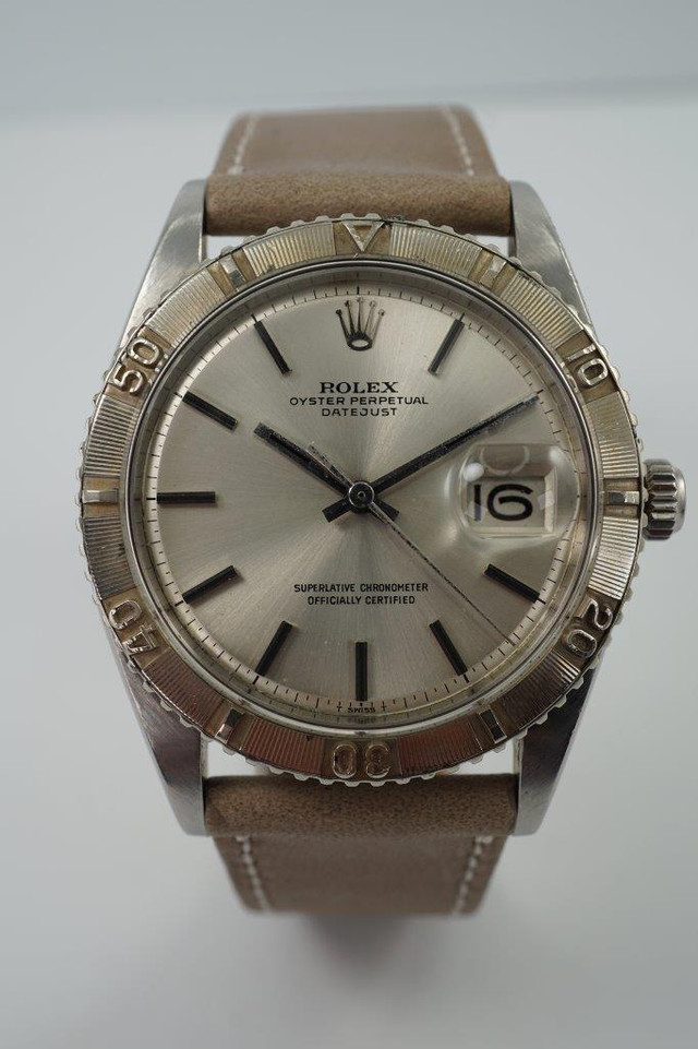 A nice vintage Rolex Datejust 1625 Thunderbird in stainless steel, crafted circa 1971. 36 mm steel case housing bidirectional gold engine-turned finish bezel, non-lume silver dial, silver applied stick markers and hands with inner black, and date aperture. Beautiful patina with original finish, an excellent timeless addition to a vintage collection.

Original non-lume dial, hands and crown.
Case measures 36 x 44 mm, 12 mm thick.  
Rolex cal. 1570, 26 jewel automatic winding.
Rolex acrylic crystal #117, newly installed.
Serial# 2701xxx Movement# D221721
Case back date code 1/71.
New premium non-Rolex grey taupe leather strap. 
20 mm between lugs.
Modeled on size 7 3/4 and 6 inch wrist.