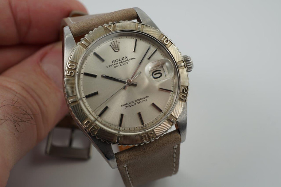 A nice vintage Rolex Datejust 1625 Thunderbird in stainless steel, crafted circa 1971. 36 mm steel case housing bidirectional gold engine-turned finish bezel, non-lume silver dial, silver applied stick markers and hands with inner black, and date aperture. Beautiful patina with original finish, an excellent timeless addition to a vintage collection.

Original non-lume dial, hands and crown.
Case measures 36 x 44 mm, 12 mm thick.  
Rolex cal. 1570, 26 jewel automatic winding.
Rolex acrylic crystal #117, newly installed.
Serial# 2701xxx Movement# D221721
Case back date code 1/71.
New premium non-Rolex grey taupe leather strap. 
20 mm between lugs.
Modeled on size 7 3/4 and 6 inch wrist.