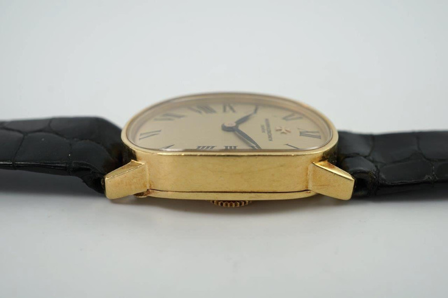 A wonderful Vacheron Constantin ladies watch reference 18220 in 18k yellow gold, crafted during the 1950s. Strong oval 18mm case with 12mm silhouette housing a gold colored dial, black Roman numeral hour markers and blackened-steeled feuille hands. This dainty accessory can be worn for a variety of occasions, a classic with the gold frame and black crocodile strap. 

Minimal scratches.
Original dial, hands and crown. 
Case measures 18 x 28mm, 12mm thick.
V+C cal. 1430, 18 jewels manual winding.
Sapphire crystal.
Serial# 5201xx Movement# 674457
V+C black crocodile strap (85% condition approximation).
V+C 18k gold buckle.
Modeled on a 6 inch wrist.